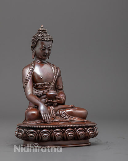 Side profile of oxidized copper Buddha sculpture showcasing detailed robe folds