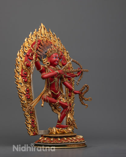 Side profile of red Kurukulla deity holding bow and arrow, showing intricate jewelry