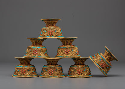 Side profile of silver-base Buddhist offering bowl with gold filigree and stone
