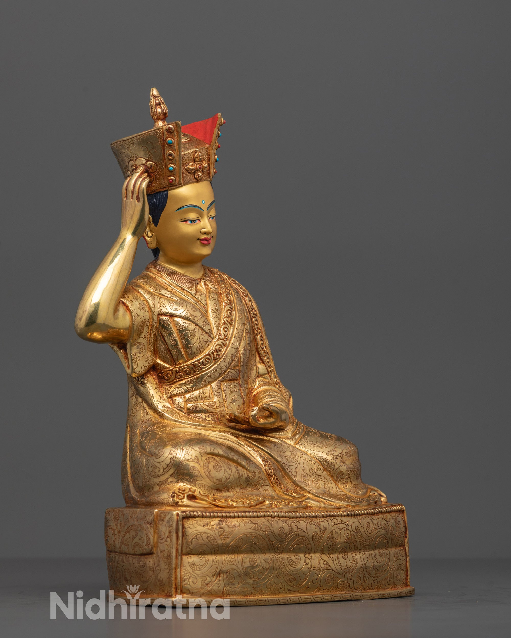 Side profile of the 24k gold-gilded Karmapa Statue, highlighting intricate robe details