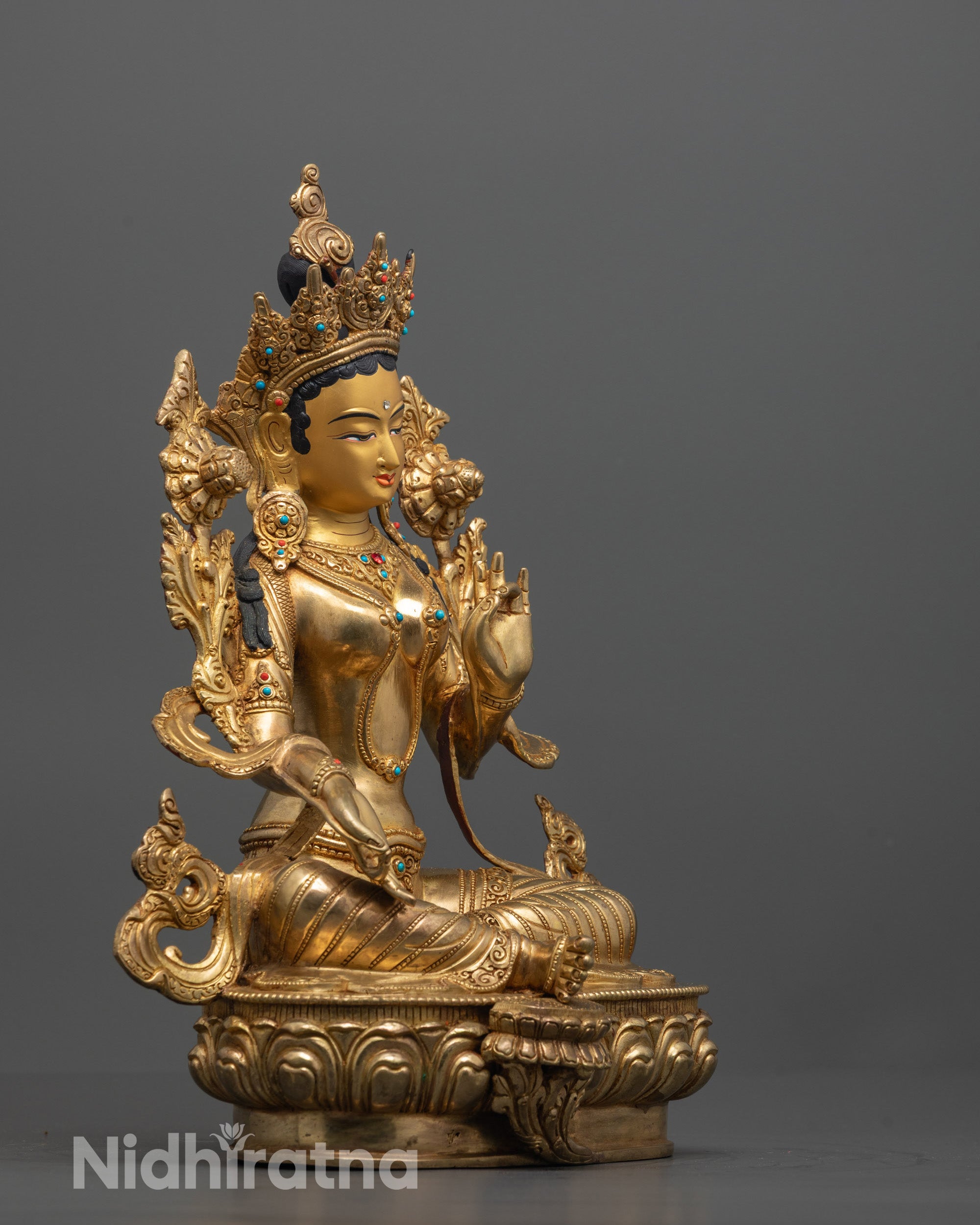 Side profile of the Green Tara Statue highlighting the varada mudra hand gesture