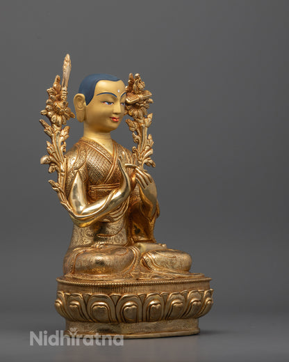 Side profile showing detailed robes and fire gold gilding on Je Tsongkhapa statue

