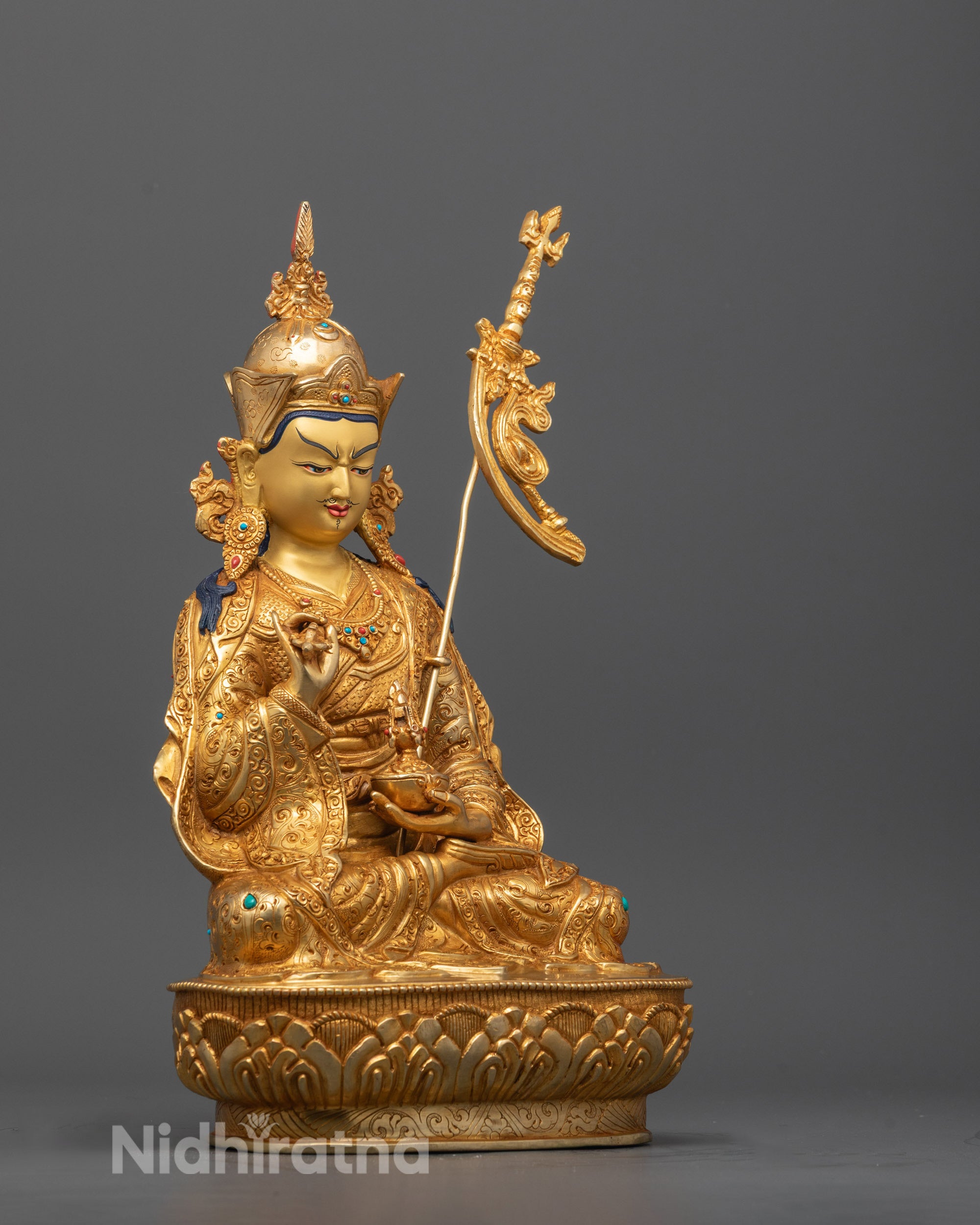 Side profile showing intricate carvings and gold gilding on the Guru Rinpoche Statue