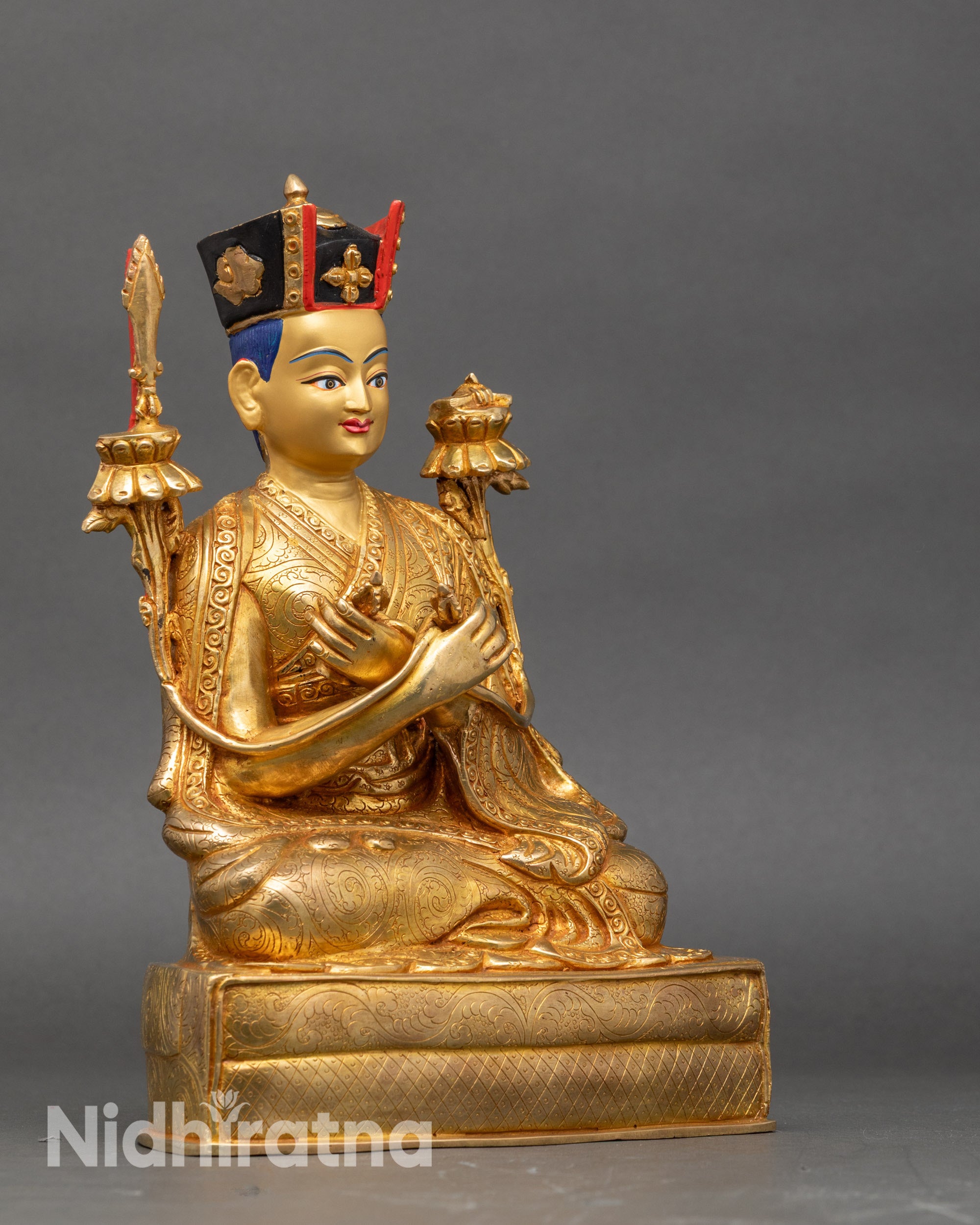 Side view 16th Karmapa holding utpala stem with flaming sword, vajra, and bell
