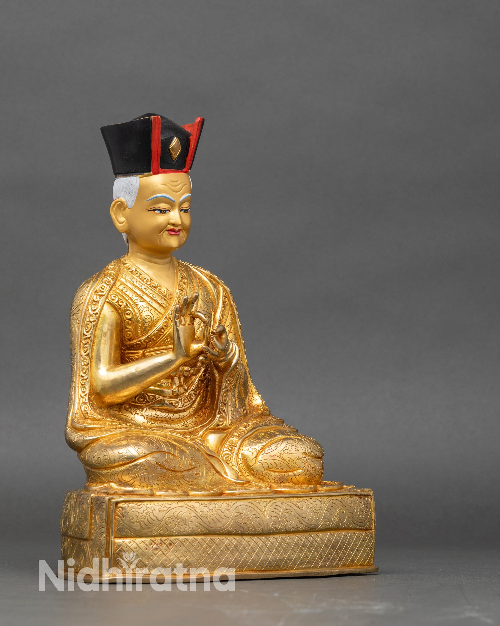 Side view 1st Karmapa Dusum Khyenpa statue Dharmachakra mudra gold gilded