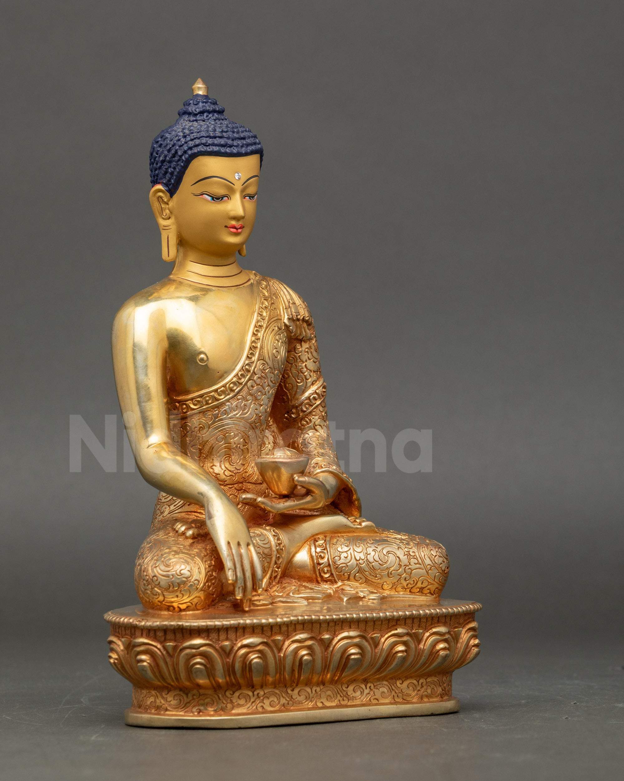 Side view 24K Gold Buddha sculpture with flowing robes and floral fire-gilding motifs