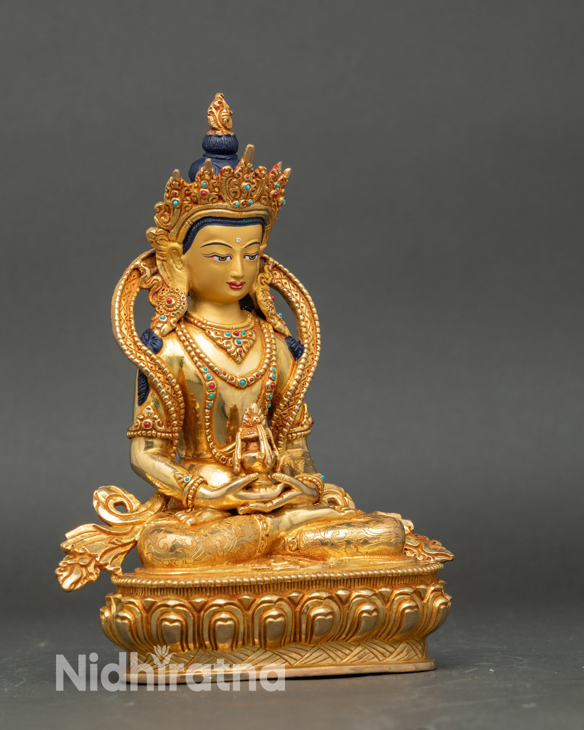 Side view Amitayus statue holding medicinal vase symbolizing longevity and healing