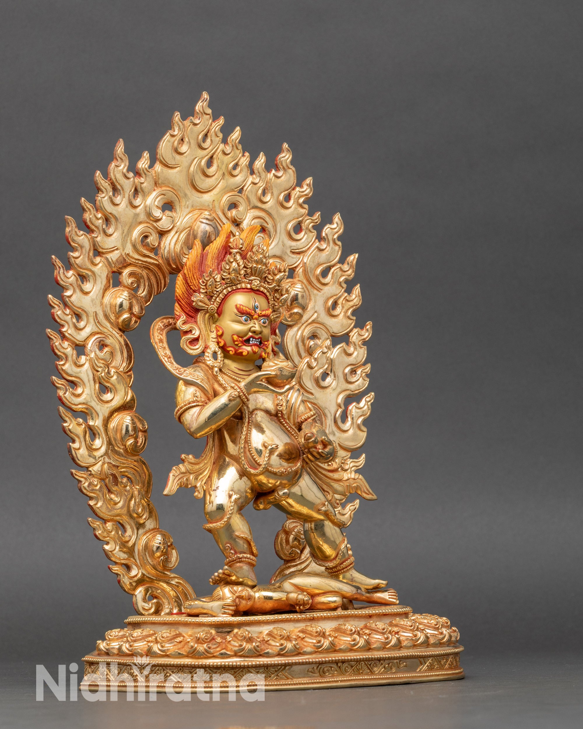 Side view Black Dzambhala holding skull cup and jewel-spitting mongoose sculpture