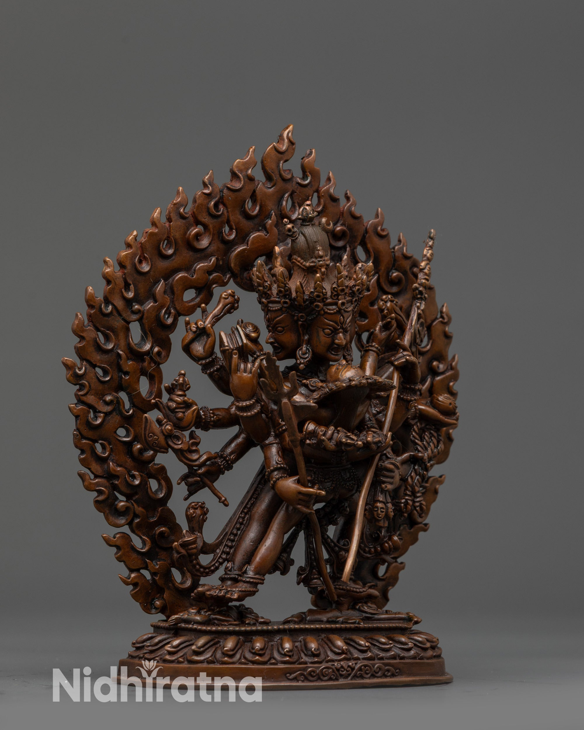 Side view Chakrasamvara statue with multiple arms holding sacred objects