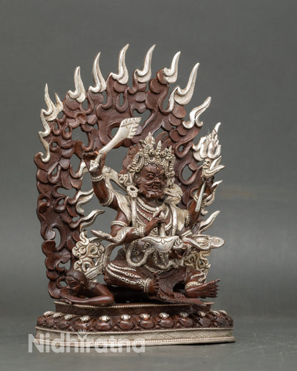 Side view Chaturbhuja Mahakala statue highlighting four arms and ritual implements