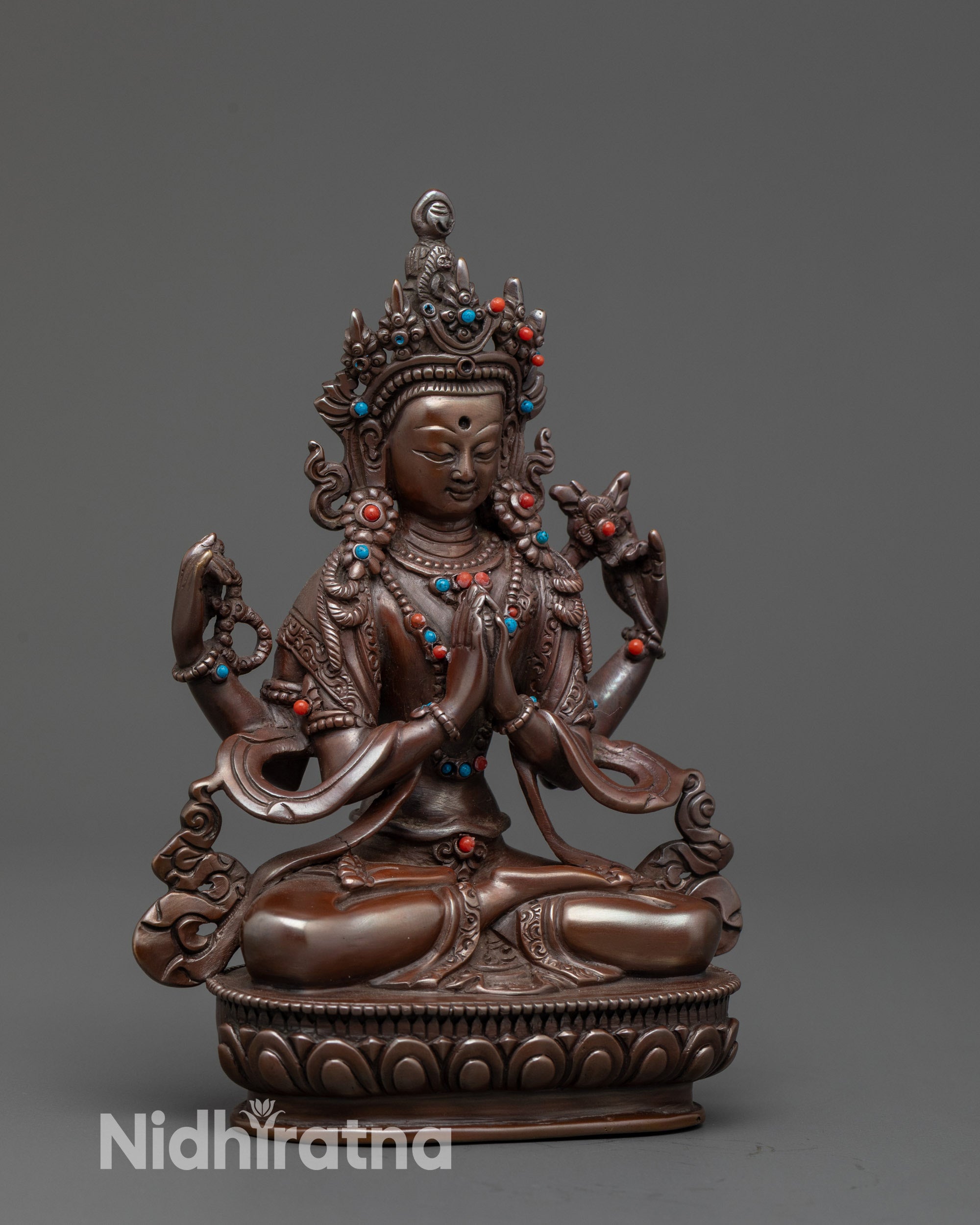 Side view Chenrezig Statue highlighting four arms and sacred objects