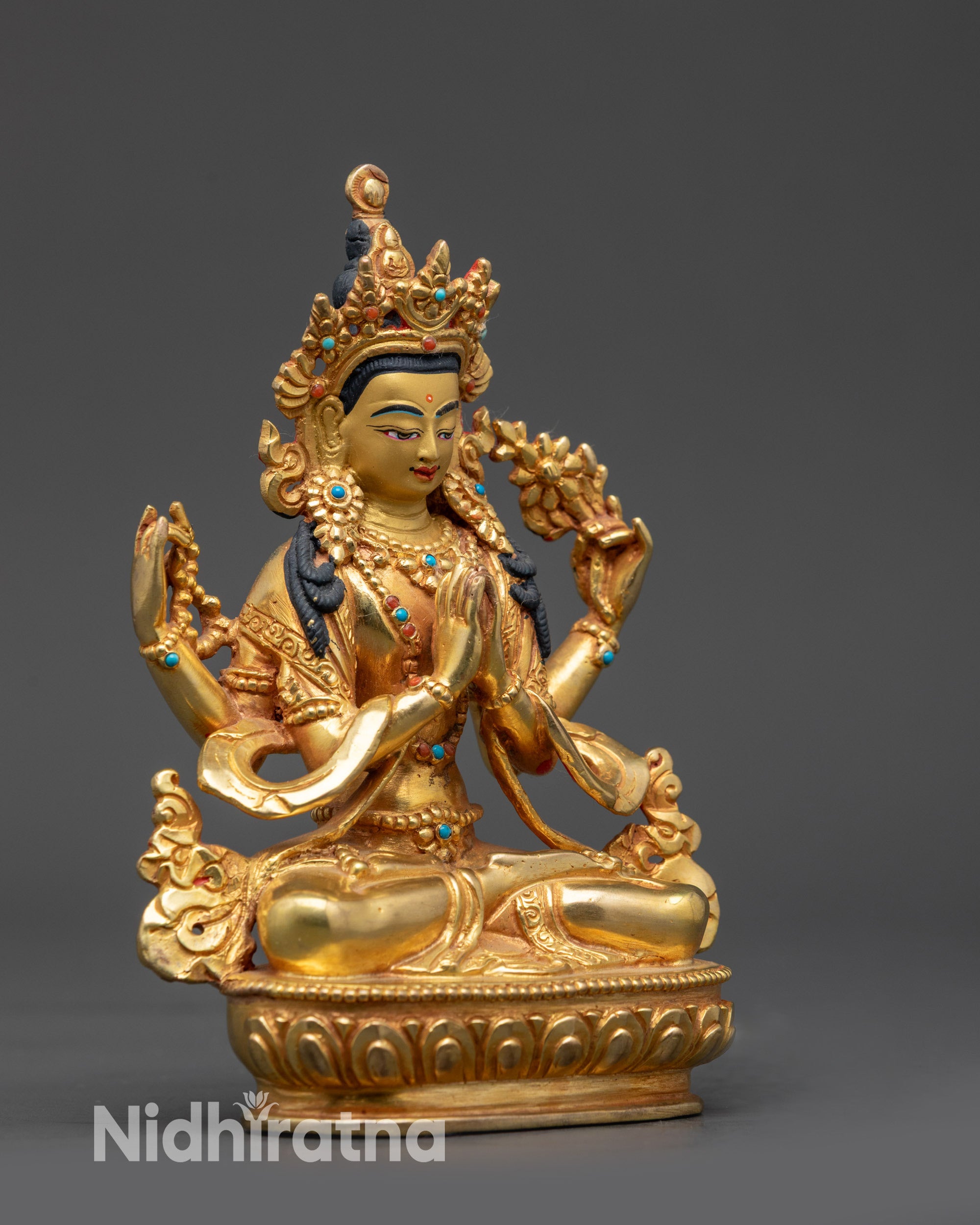 Side view Chenrezig Statue holding chintamani, lotus, and adorned with semi-precious stones
