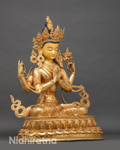 Side view Chenrezig sculpture holding wish-fulfilling jewel and lotus flower
