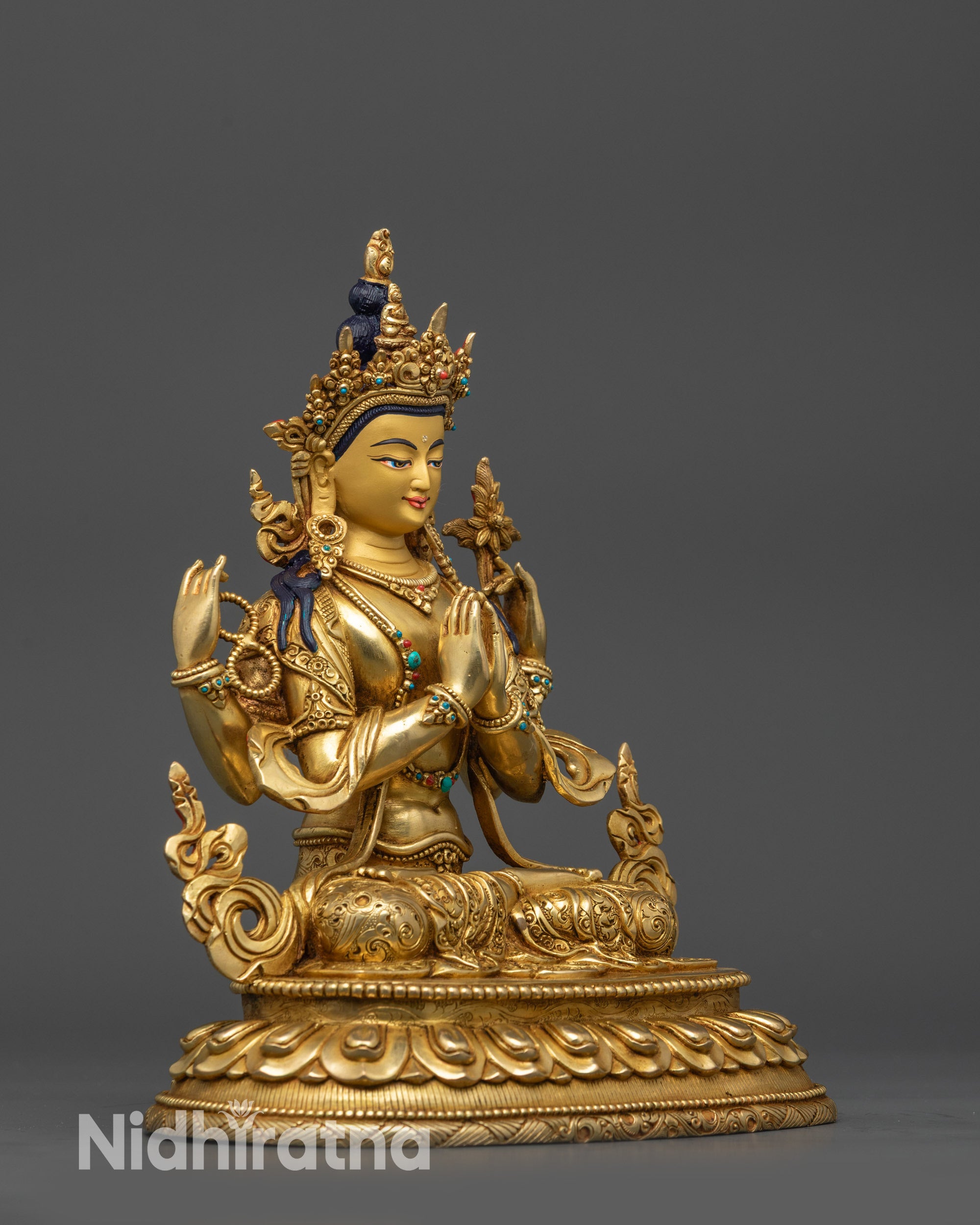 Side view Chenrezig statue showing flowing robes and four sacred hands