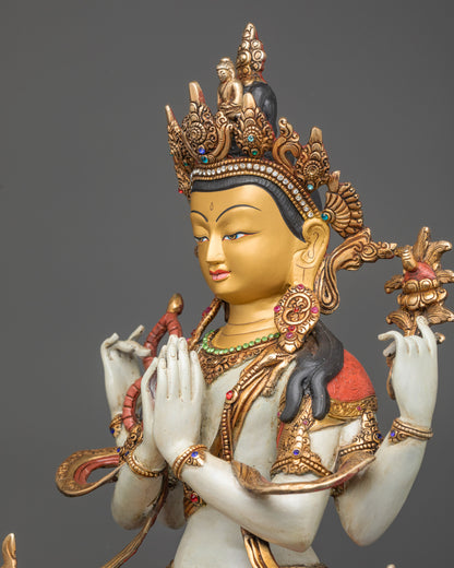 Side view Chenrezig statue with floating gold-plated robe adorned with semi-precious stones