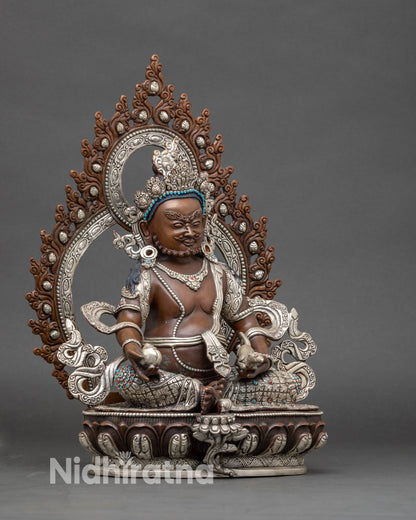 Side view Dzambhala Buddhist wealth statue with royal ease posture, lotus throne and conch shell