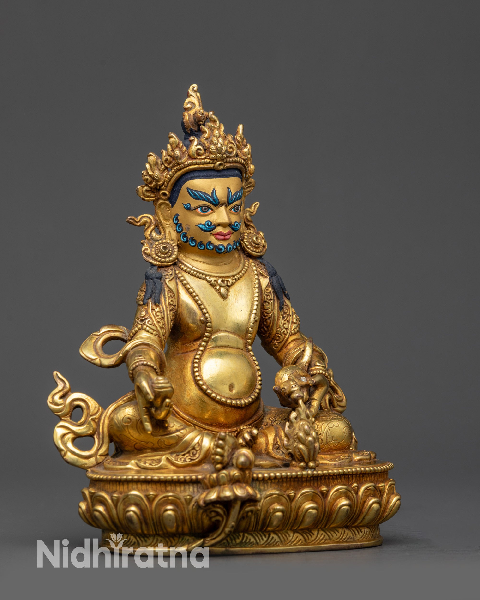 Side view Dzambhala Statue holding citrion fruits and spitting a mongoose
