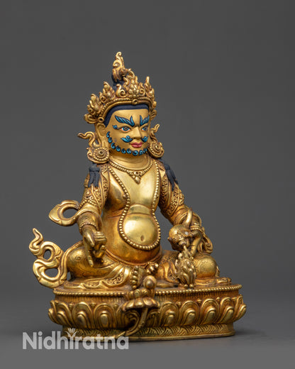 Side view Dzambhala Statue holding citrion fruits and spitting a mongoose
