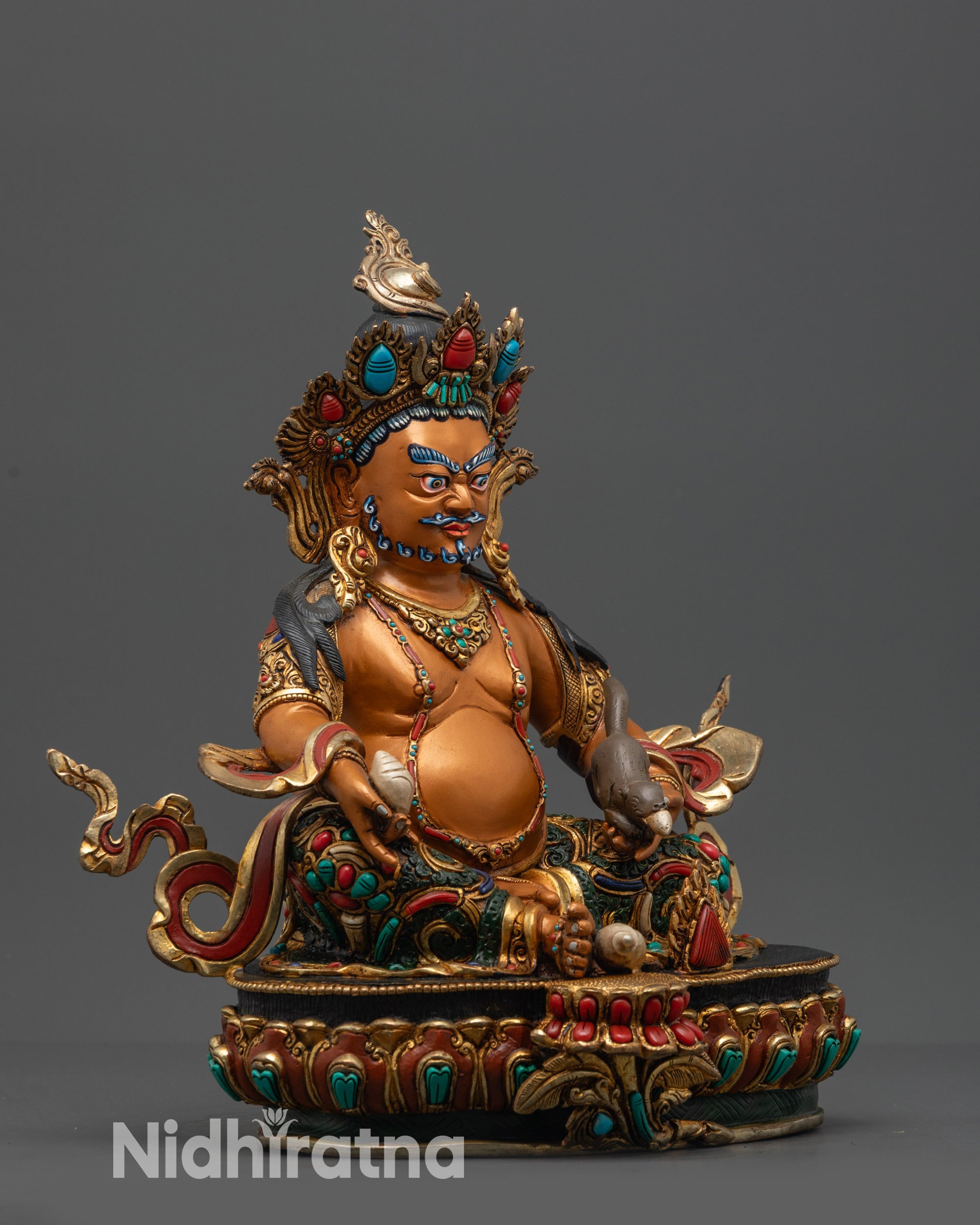 Side view Dzambhala Statue holding citron fruit and jewel spitting mongoose
