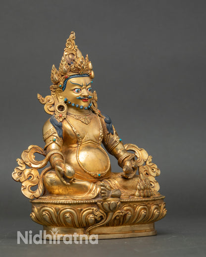 Side view Dzambhala statue holding citron fruits and jewel-spitting mongoose