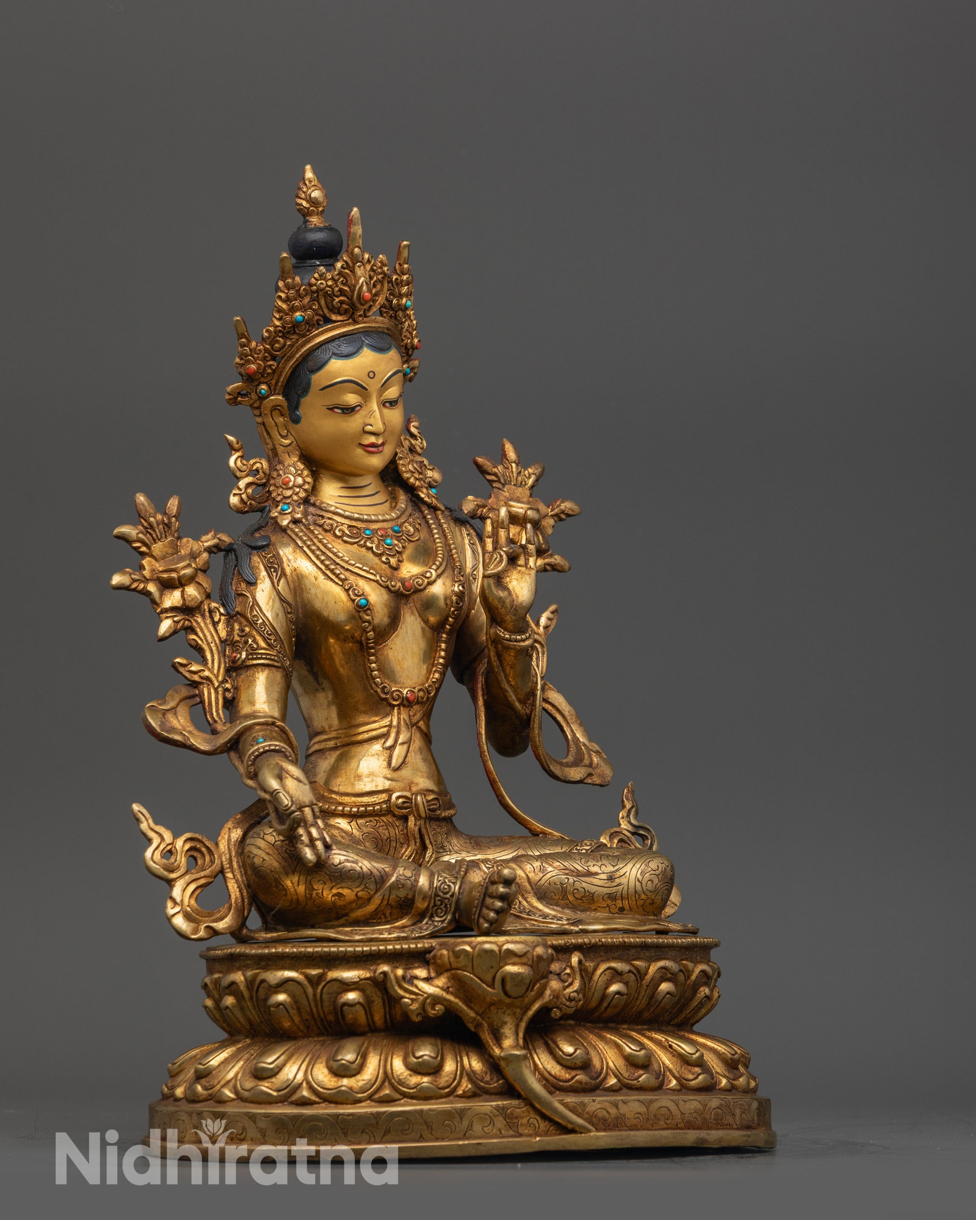 Side view Green Tara Statue highlighting flowing robes and royal ease seated pose

