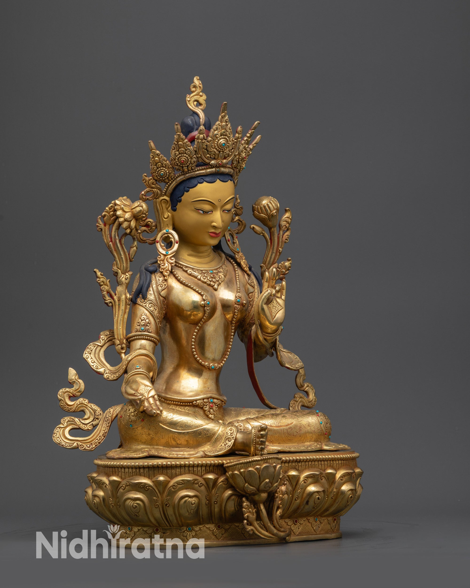 Side view Green Tara Statue showing flowing robe, intricate jewelry, and lotus seat patterns