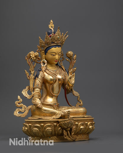 Side view Green Tara Statue showing flowing robe, intricate jewelry, and lotus seat patterns