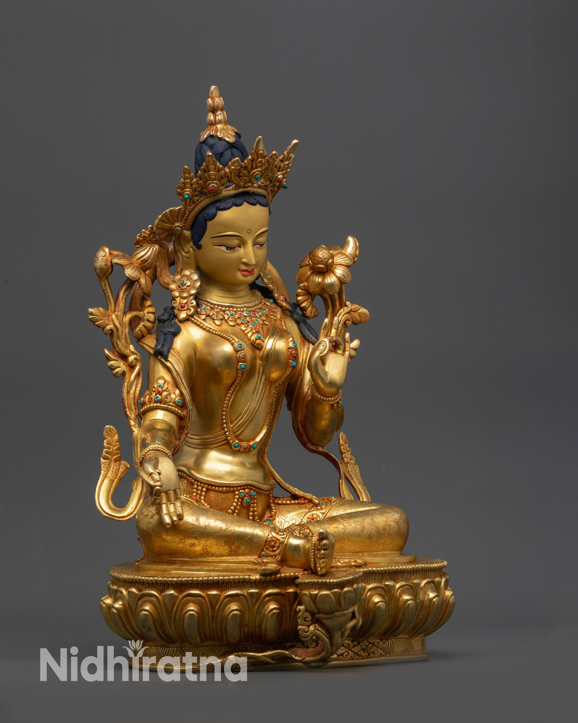 Side view Green Tara idol with tranquil expression and detailed moon disc base
