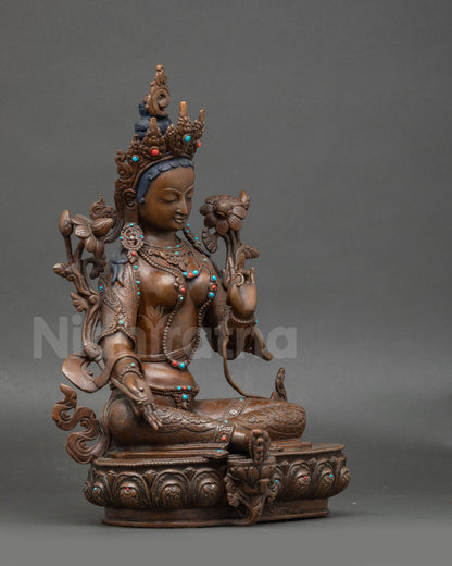 Side view Green Tara seated on lotus throne, handcrafted Nepalese copper statue