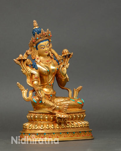 Side view Green Tara statue, royal ease posture, right leg extended, Varada and Vitarka mudra