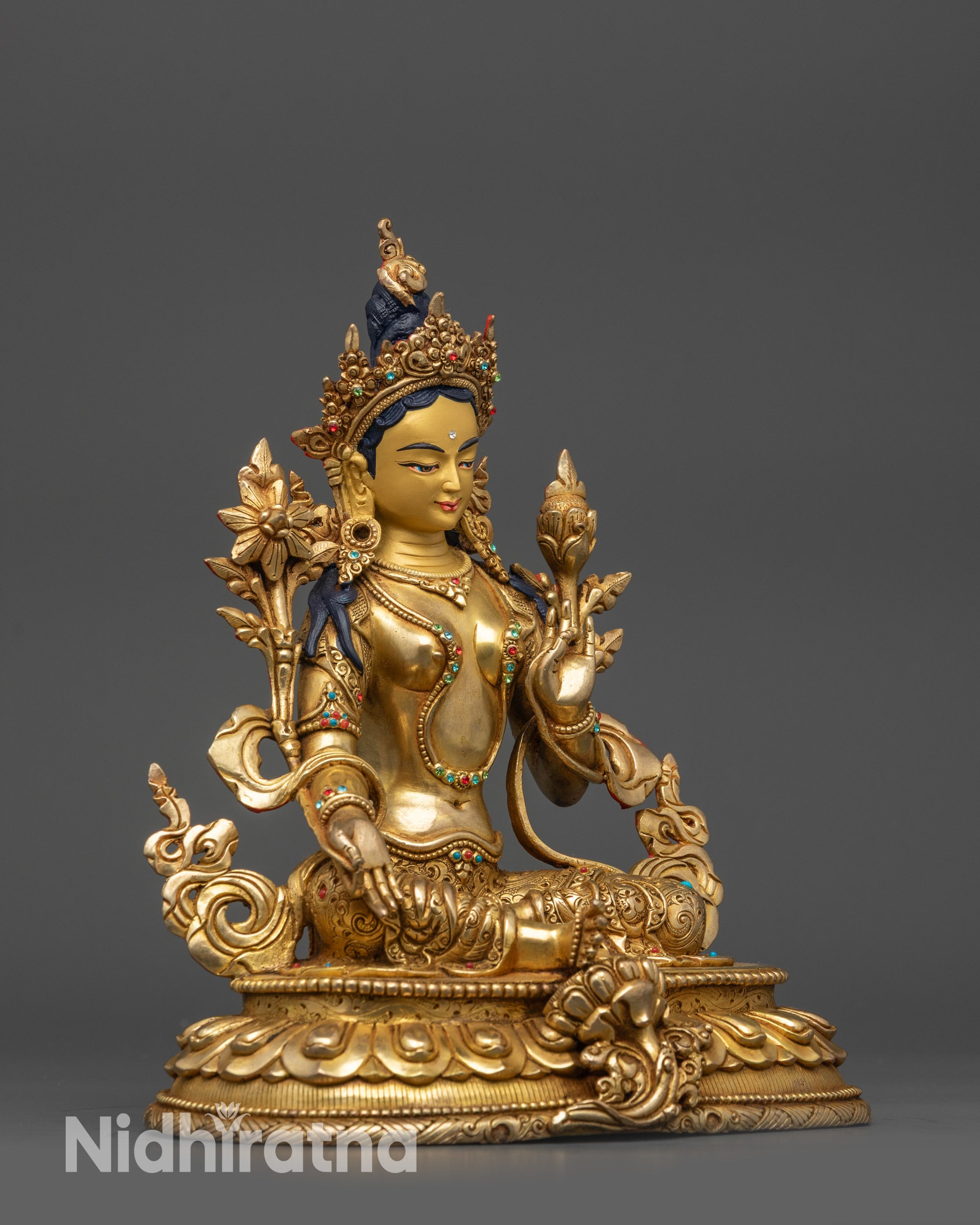 Side view Green Tara statue showing intricate lotus seat and carved jewelry