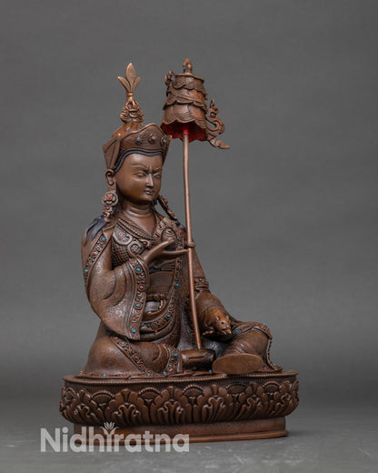Side view Guru Norlha statue with victory banner on shoulder, lotus pedestal detail