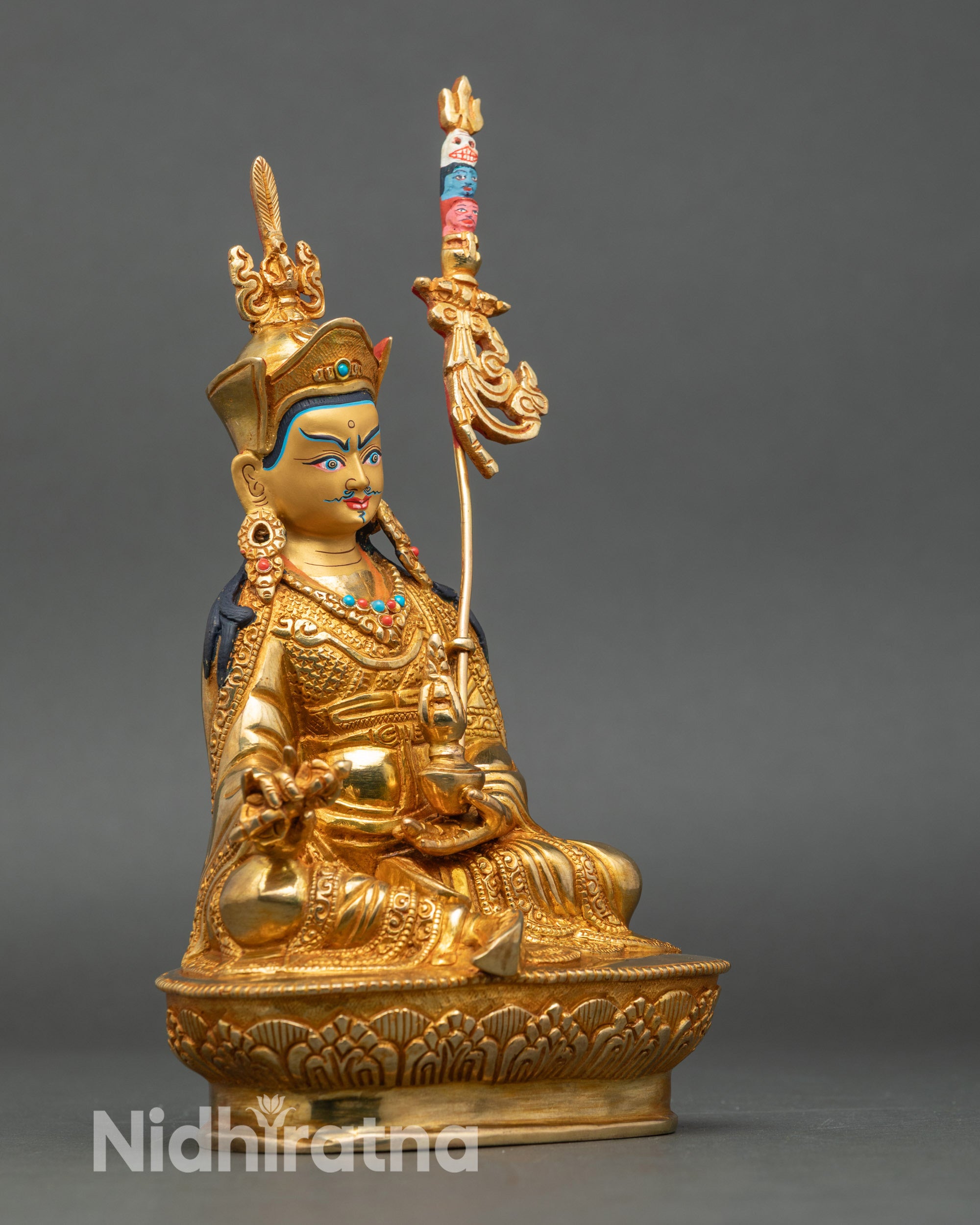 Side view Guru Padmasambhava seated on lotus throne holding dorje and kalash