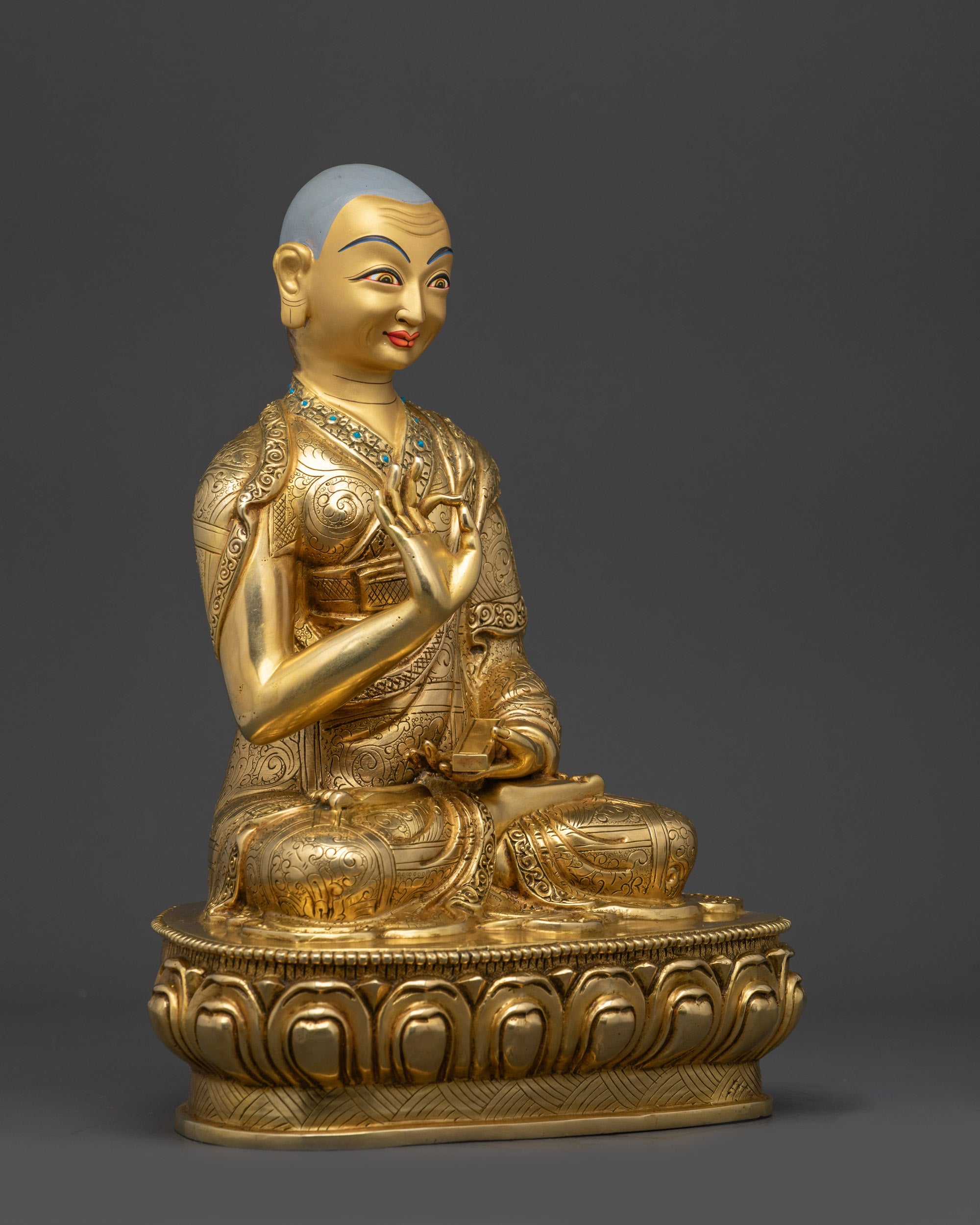 Side view Gyaltsab Je statue showing detailed monastic robes and lotus seat