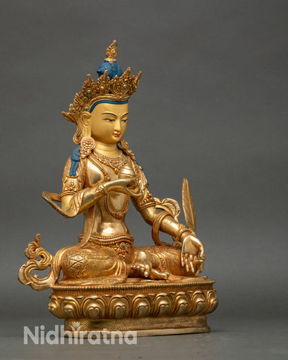 Side view Ksitigarbha statue with lotus seat and detailed Newari copper-gold