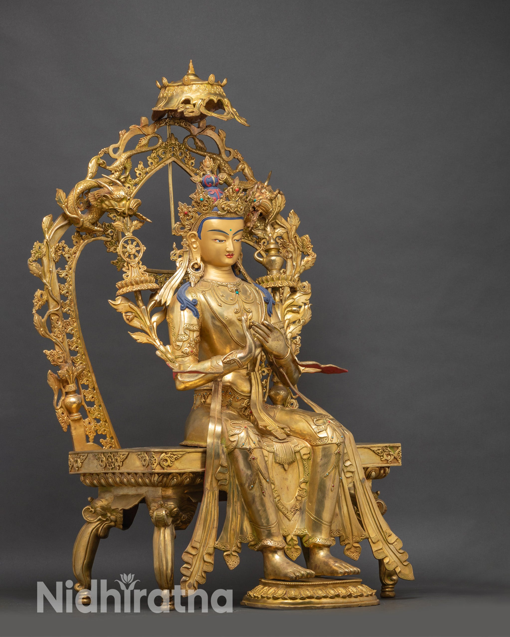 Side view Maitreya Buddha statue with lotus, Dharma wheel and kalasha on ornate throne