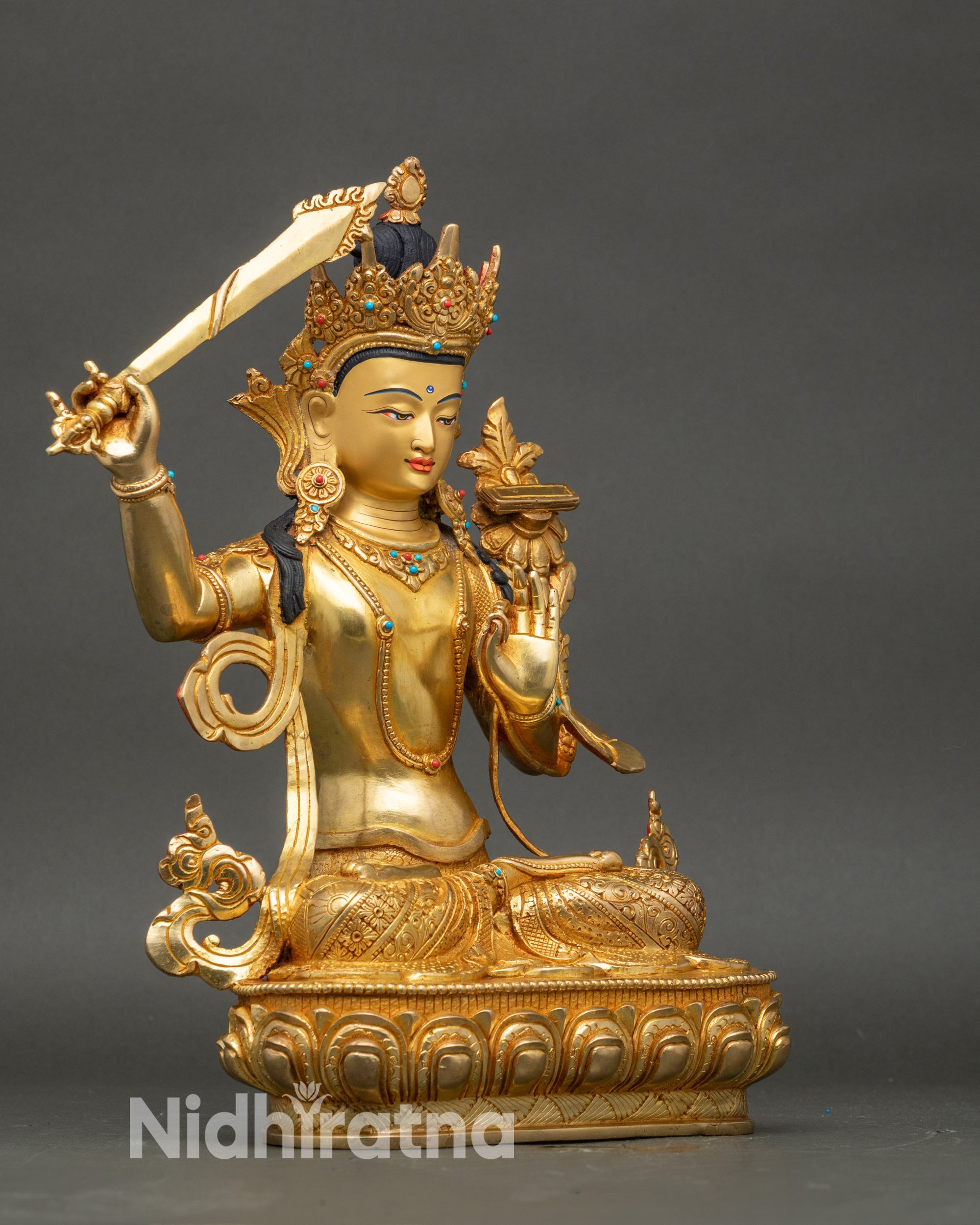 Side view Manjushri Bodhisattva seated on lotus throne with ornate crown and jewelry