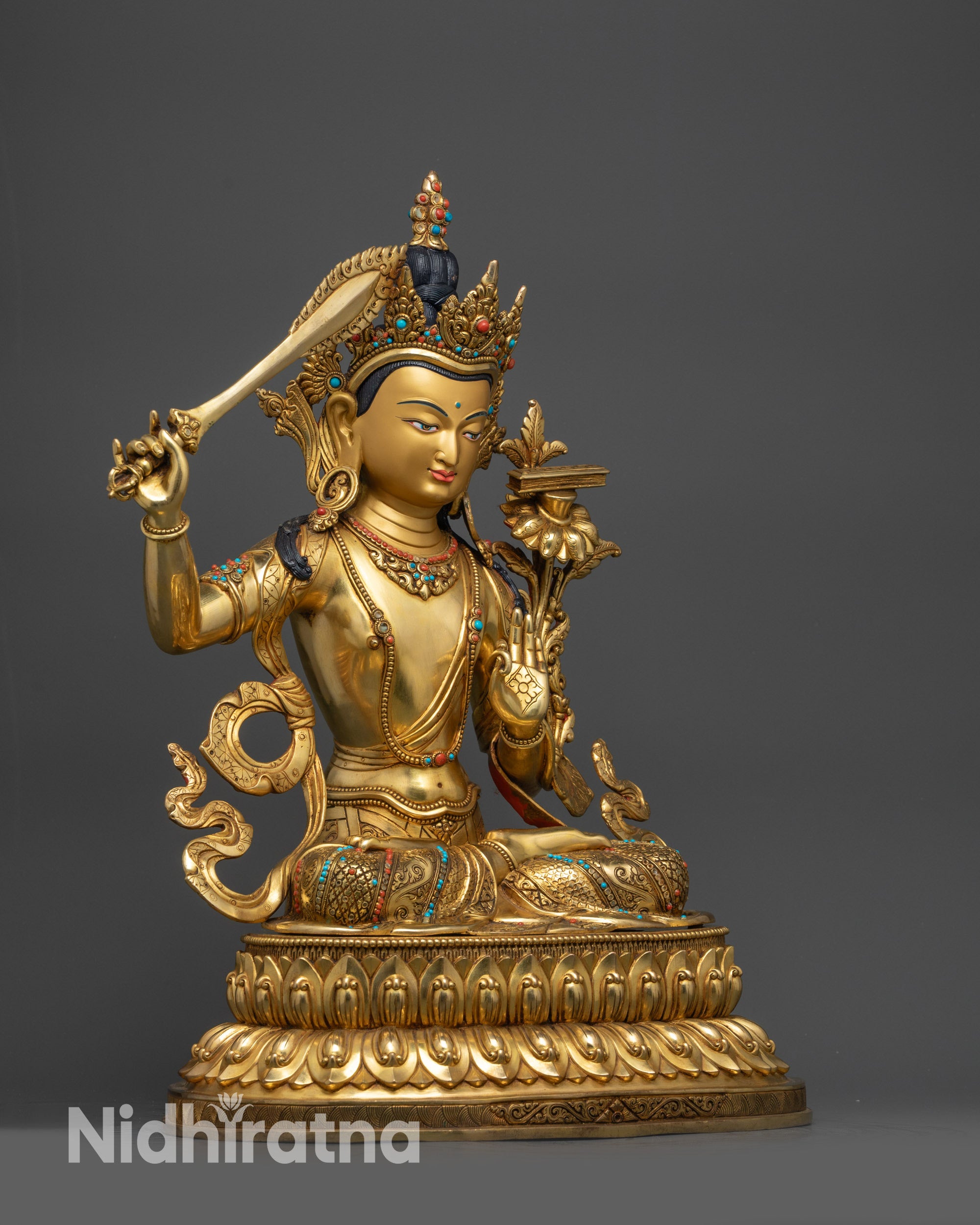 Side view Manjushri Statue with flaming sword and Prajna Paramita scripture on utpala flower

