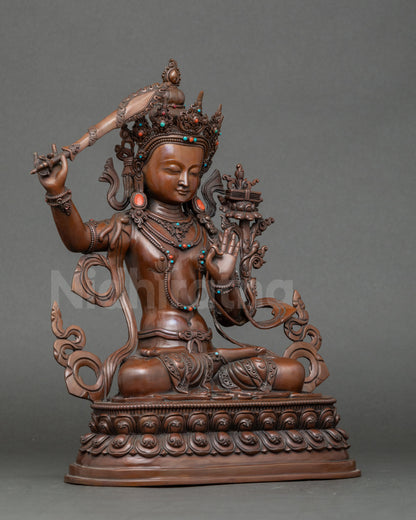 Side view Manjushri sculpture, seated on lotus throne holding Prajnaparamita scripture