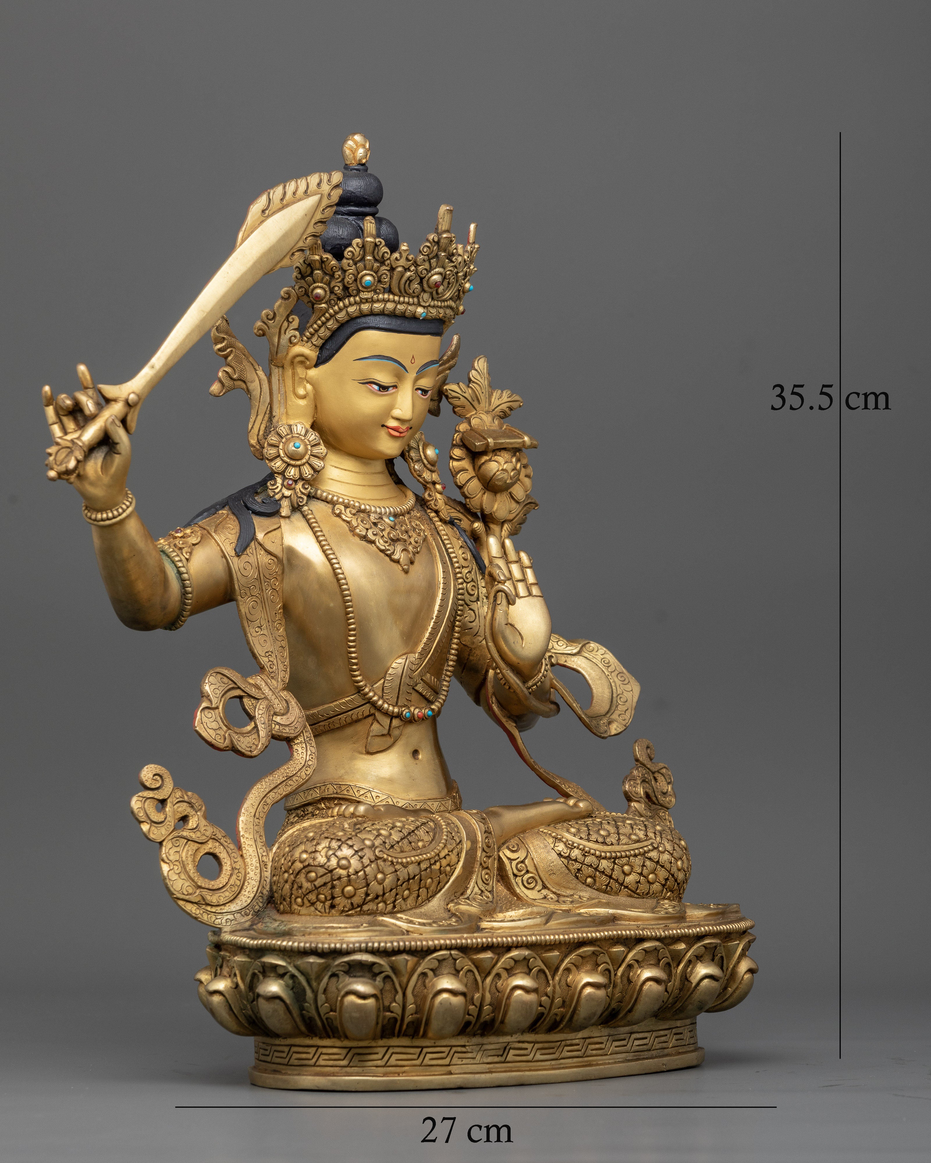 Side view Manjushri statue with intricately carved floral robes and a mythical creature on the back of the throne, Nepalese copper art