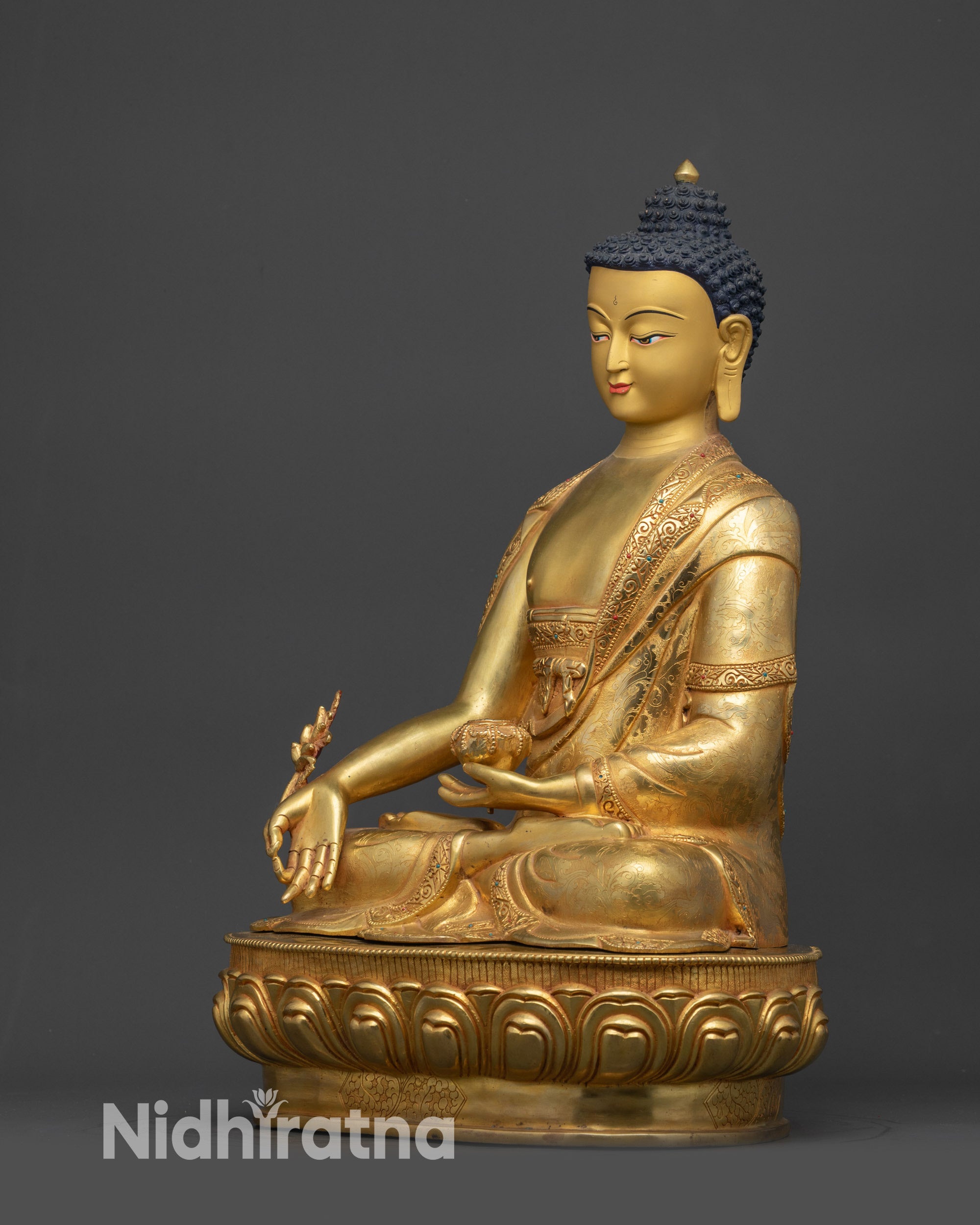 Side view Medicine Buddha Bhaisajyaguru seated on lotus seat with Dharma wheel symbol
