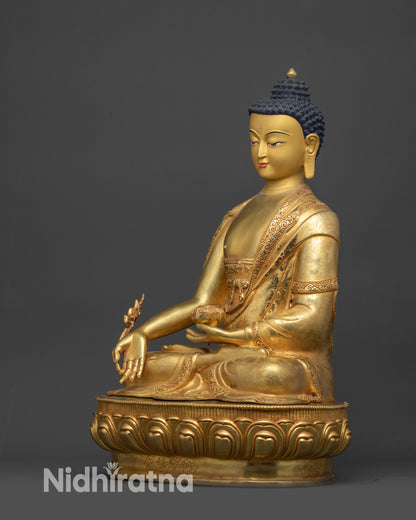 Side view Medicine Buddha Bhaisajyaguru seated on lotus seat with Dharma wheel symbol
