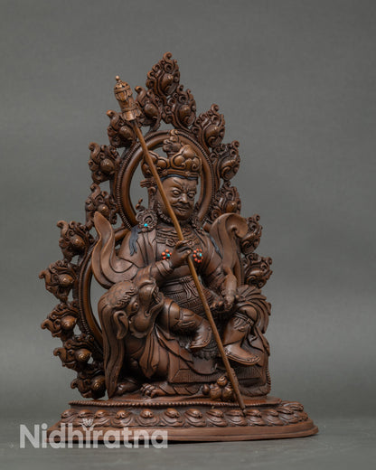 Side view Namtoshe statue holding victory banner and mongoose, handcrafted Nepalese deity