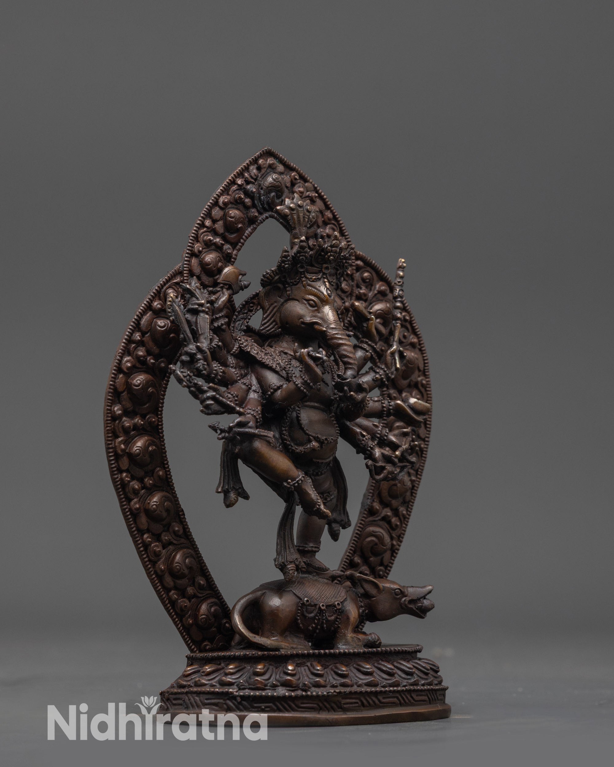 Side view Oxidized Ganesha Statue highlighting flowing robes and detailed halo carvings