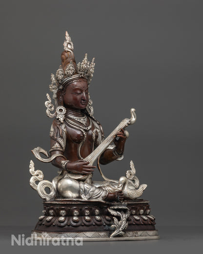 Side view Oxidized Saraswati Statue seated in royal ease pose with detailed veena