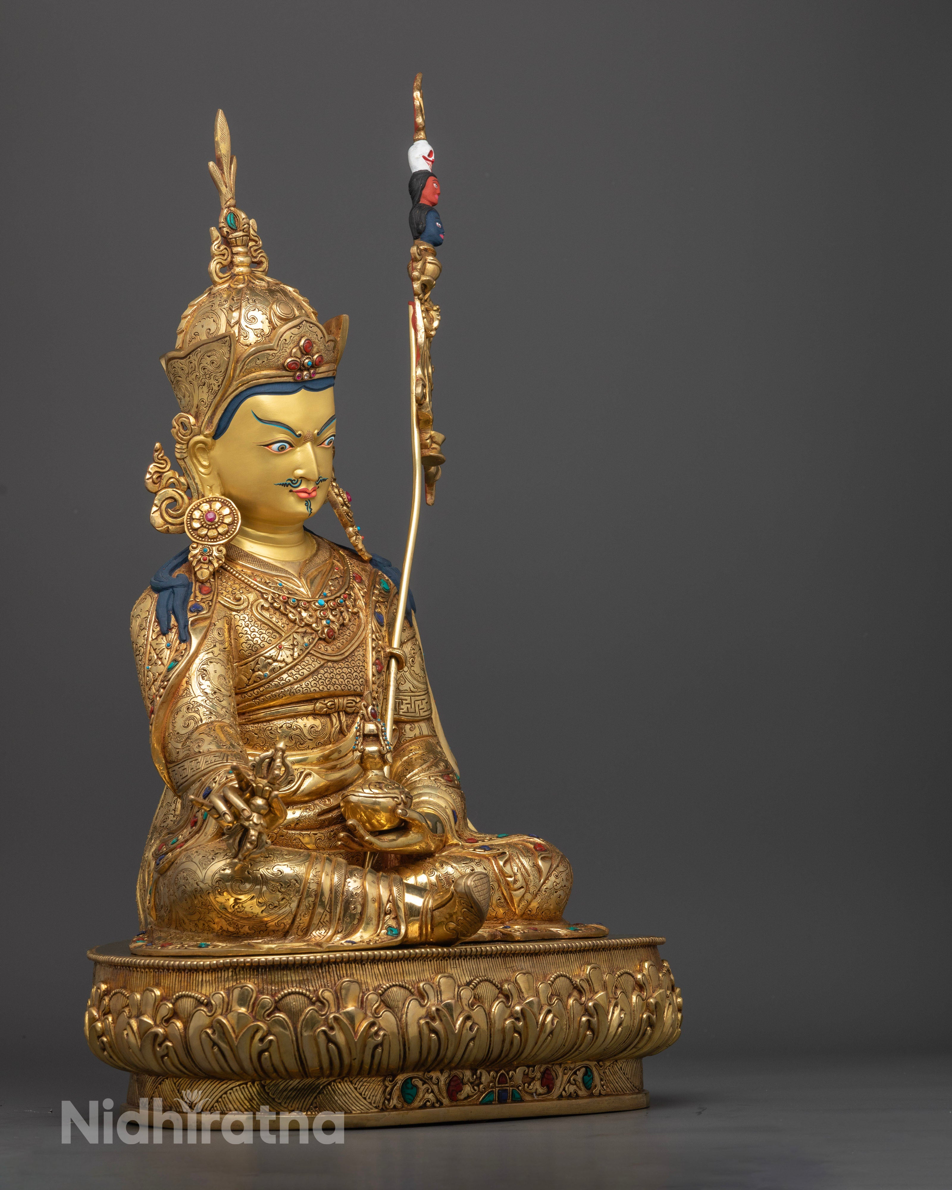 Side view Pema Jungne holding vajra and skull cup, seated on lotus pedestal, handcrafted Nepalese Buddhist art