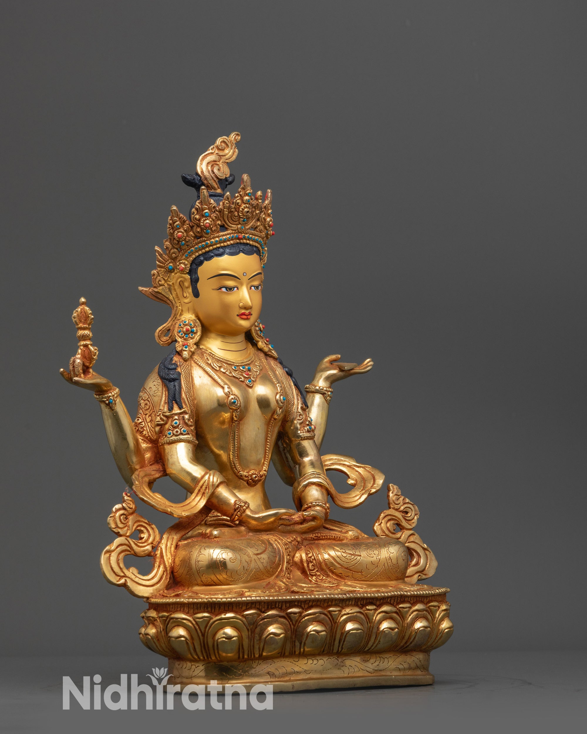 Side view Prajna Paramita Statue depicting four arms holding sutra and vajra