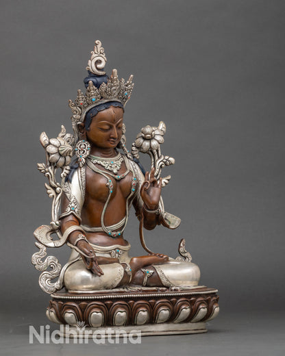 Side view Tara of Compassion sculpture seated on lotus pedestal with extended right leg