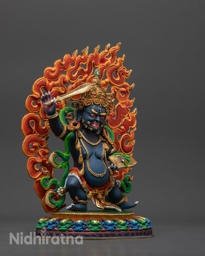Side view Tibetan Manjushri statue standing on multi-colored lotus with fire halo

