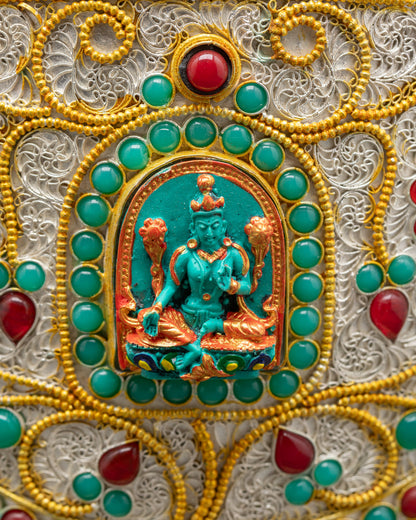 Side view Tibetan rice pot featuring carved Green Tara with turquoise and gold finish